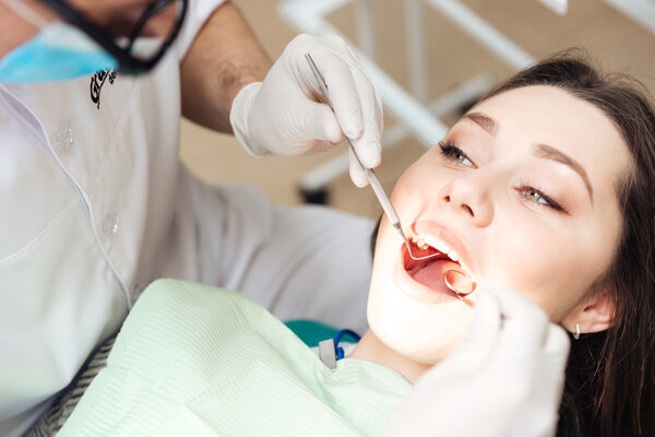 Dentist doing dental treatment to a woman