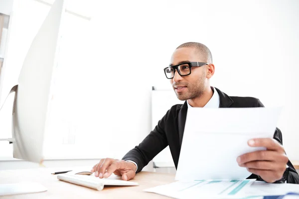 Handsome young businessman working with documents in office — Stock Photo, Image