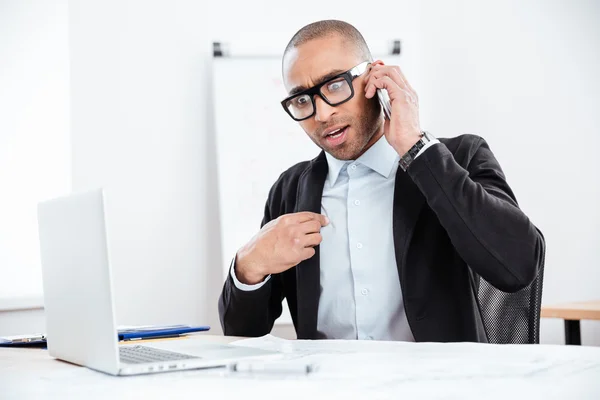 Portrait of a surprised businessman talking on mobile phone — Stock Photo, Image