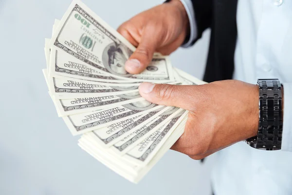 Hands of african young man holding money — Stock Photo, Image