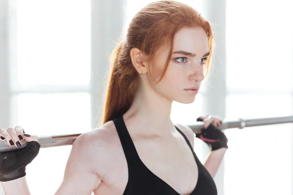 Close-up portrait of a woman doing exercises with barbell — Stock Photo, Image