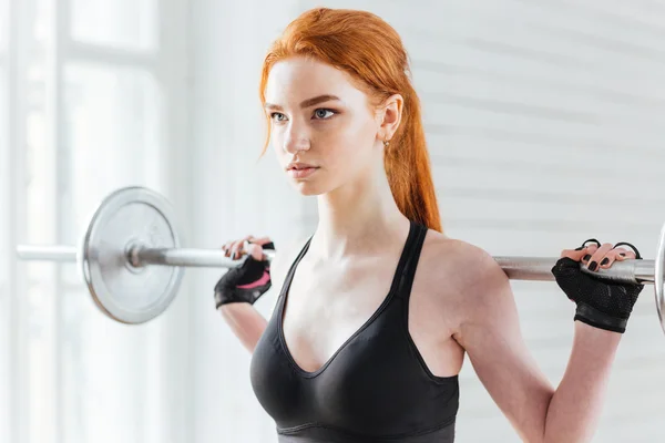 Close-up portrait of a beautiful fitness woman with barbell — Stock Photo, Image