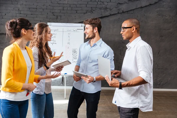 Group of business people standing and talking in conference room — Stock Photo, Image