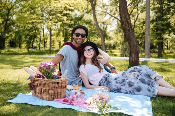 Feliz pareja joven haciendo un picnic en el parque — Foto de Stock