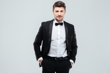 Confident young man in tuxedo with bowtie clipart