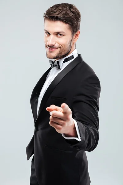 Happy confident man in tuxedo with bowtie pointing on you — Stock Photo, Image