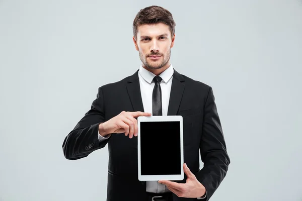 Handsome young businessman holding blank screen tablet — Stock Photo, Image