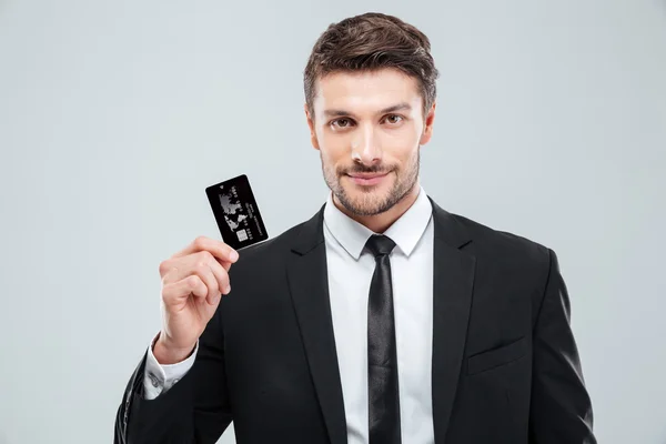 Handsome young businessman holding credit card — Stock Photo, Image