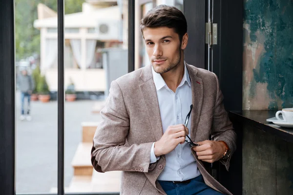 Modern businessman drinking coffee in cafe — Stock Photo, Image