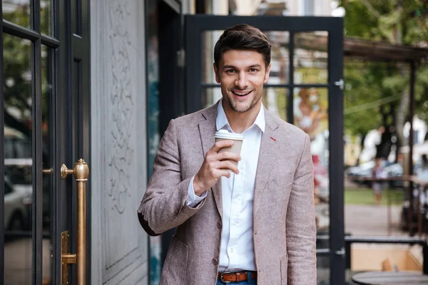 Молодий бізнесмен п'є чашку кави на відкритому повітрі — стокове фото