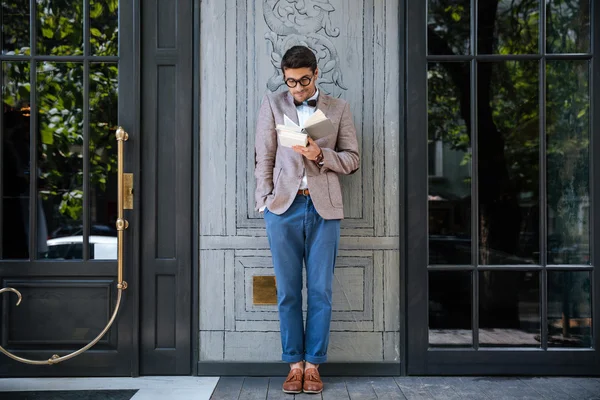 Young nerd man with books got an idea