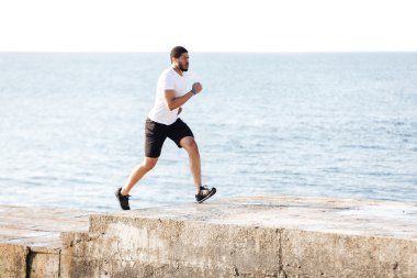 Müzik ve iskelede çalışan konsantre adam