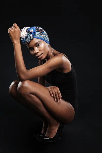 Beautiful african woman in bodysuit posing in studio — Stock Photo, Image