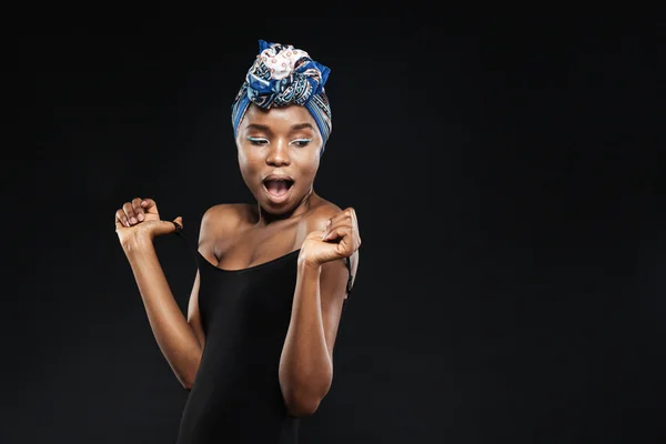 Surprised african woman with beautiful body in black bodysuit — Stock Photo, Image