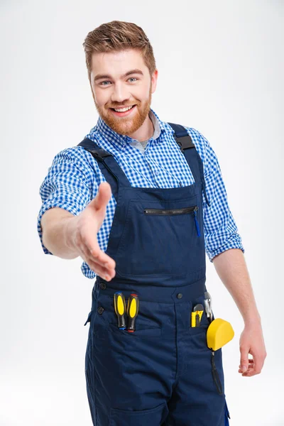 Щасливий чоловік будівельник розтягує руку для рукостискання — стокове фото