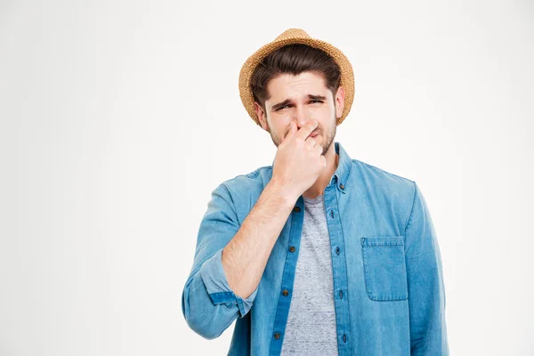 Upset man covered nose by hand and feeling bad smell — Stock Photo, Image