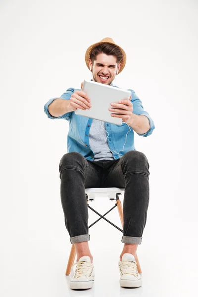 Retrato de um homem casual engraçado jogando usando tablet computador — Fotografia de Stock