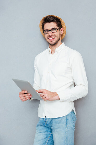Portrait of a happy man using tablet computer