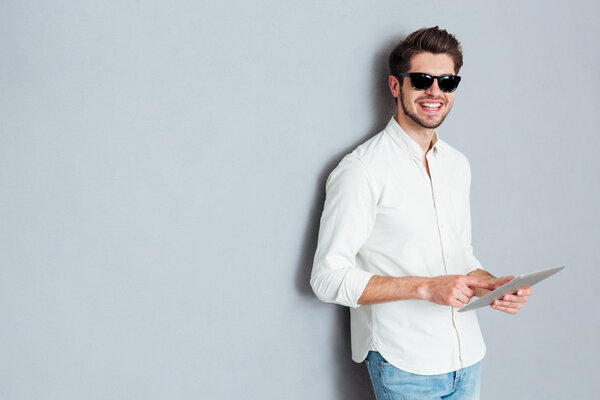 Portrait of a young man holding tablet computer