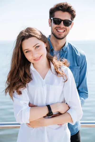 Portrait of a young couple standing together hugging — Stock Photo, Image