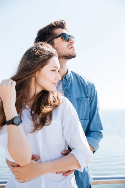 Portrait of a young couple standing together hugging — Stock Photo, Image