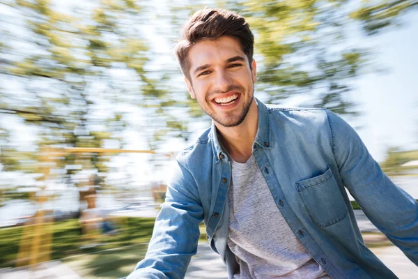 Happy young handsome man having fun at the park — Stock Photo, Image