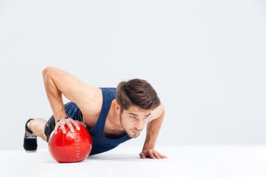 Sports man working out with fitness ball