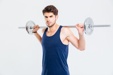 Çekici genç sporcu ayakta ve halter tutan