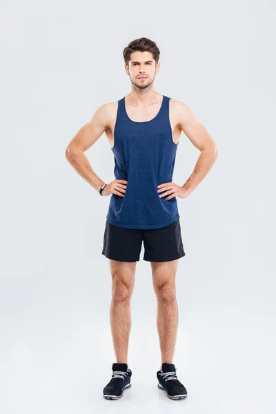 Full length portrait of sportsman standing with hands on hips — Stock Photo, Image