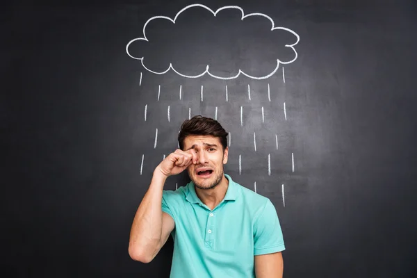 Unhappy disappointed young man crying under the drawn rain — Stock Photo, Image