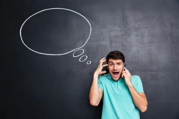 Young man using smartphone and shouting with empty speech bubble — Stock Photo, Image