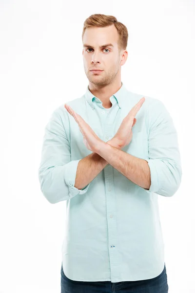 Young casual man showing stop gesture with arms crossed — Stok fotoğraf