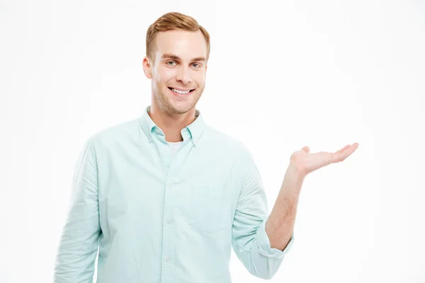 Full length portrait of man holding copyspace on the palm — Stock Photo, Image