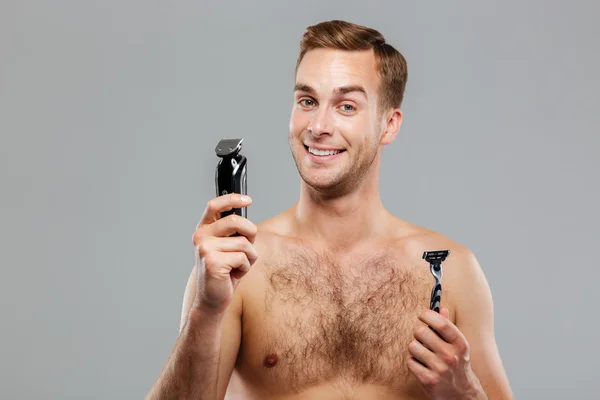 Young happy man what razor to choose — Stock Photo, Image