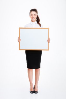 Young smiling businesswoman holding blank board