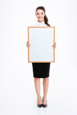 Young smiling businesswoman holding blank board