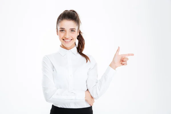 Portrait of a happy young businesswoman pointing finger away — Stock Photo, Image