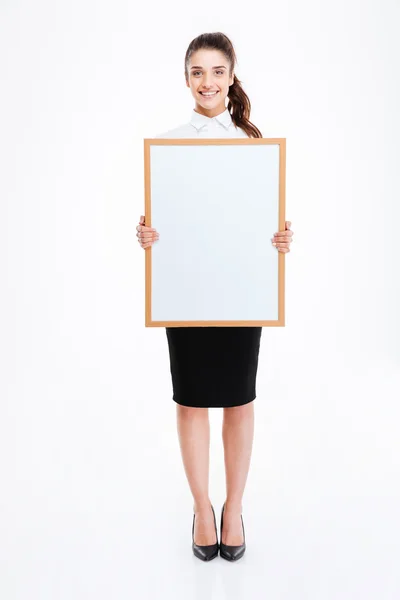 Young smiling businesswoman holding blank board — Stock Photo, Image