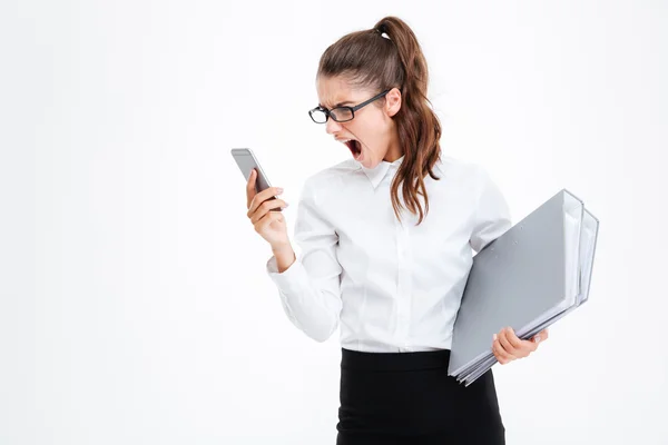 Angry mad businesswoman in glasses using cell phone and shouting — Stock Photo, Image