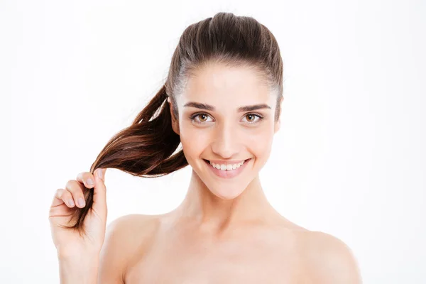 Beauty portrait of happy young woman touching her hair — Stock Photo, Image