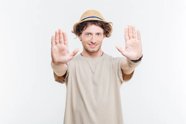 Young man in a hat showing stop gesture — Stock Photo, Image