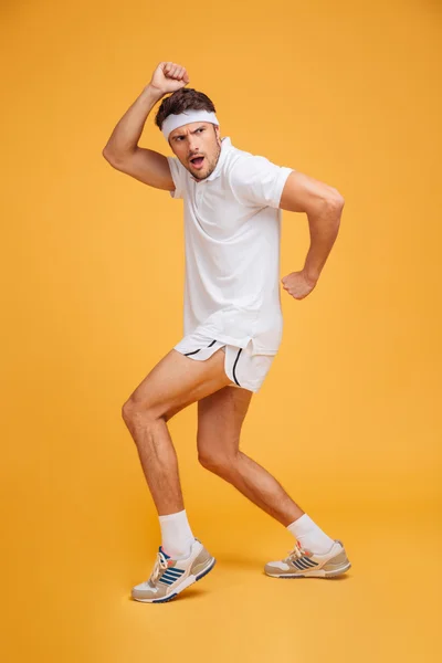 Full length of funny young spotrsman standing and posing — Stock Photo, Image