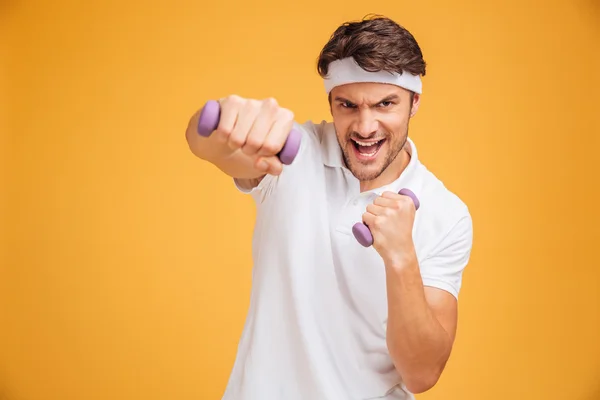 Fitness man working out with small dumbbells — ストック写真