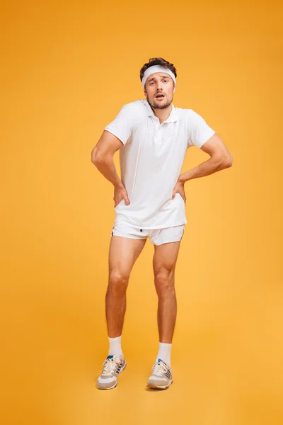 Funny tired young fitness man standing and posing — Stock Photo, Image