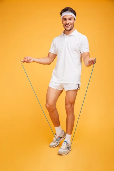 Full length portrait of a sportsman jumping with skipping rope — Stock Photo, Image