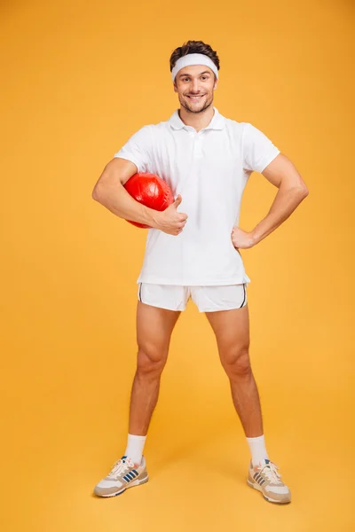 Full length portrait of a handsome man with fitness ball — Stock Photo, Image