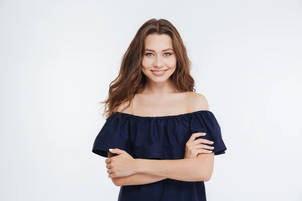 Happy beautiful young woman standing with arms crossed — Stock Photo, Image