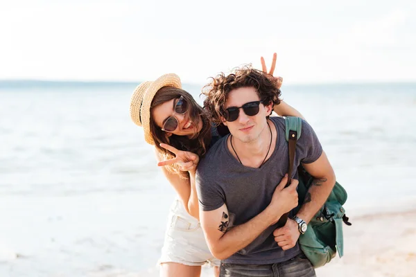 Счастливая молодая пара веселится на пляже вместе — стоковое фото