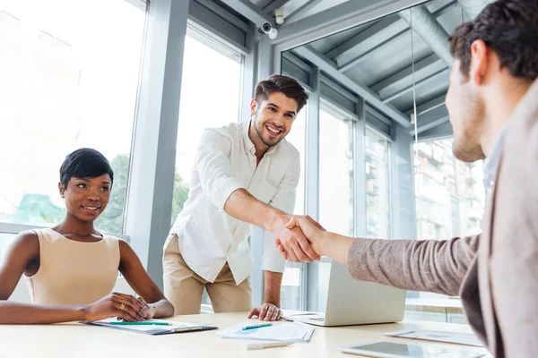 Businessmen shaking hands and ending business meeting in office — Stock Photo, Image