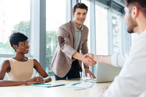 Happy business people shaking hands in office — Stock Photo, Image